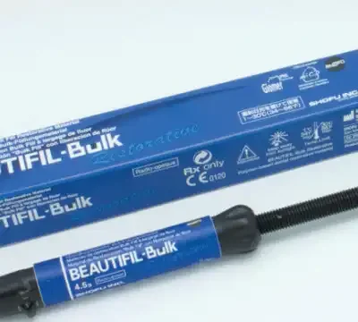 Blue Beautifil-Bulk dental filling material box and matching syringe applicator with blue label, ready for dental restoration use.