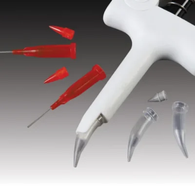 Close-up of a dental handpiece with multiple interchangeable metal tips and red syringe-like adapters floating around against a gray gradient background