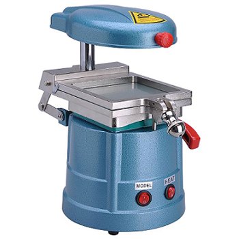 Blue compact manual tablet press with a metal die and red safety knob, featuring model/heat controls and a yellow warning on the top housing.